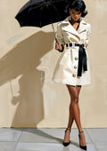 Stylized painting of a woman in a white trench coat with black belt and heels, holding a black umbrella against a beige wall.