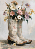Painterly bouquet of pink, white, lavender and yellow wildflowers in a pair of worn white cowboy boots on a pale background.