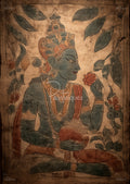 Blue-toned painted figure in profile wearing an ornate crown and necklaces, holding a red flower and round fruit among leaves.