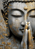 Close-up of Buddha face with closed eyes and praying hands, textured gray surface with gold leaf and golden foliage
